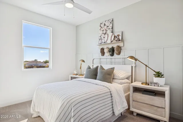 a bedroom with a bed and a lamp on table