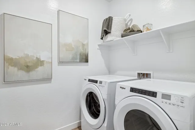 a view of walk in closet with clothes