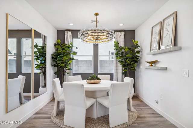 a dining room with furniture a potted plant and a chandelier