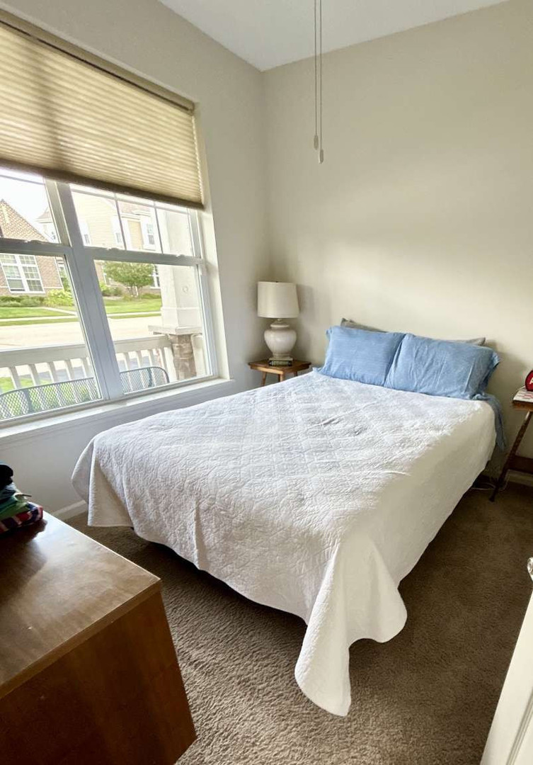 2603 Avondale Circle Naperville, IL 60564 - Photo 12 of 22 a bedroom with a bed and a large window