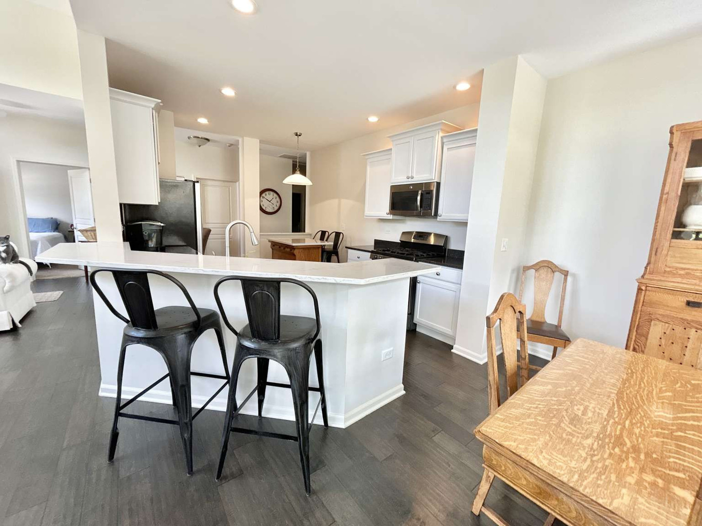2603 Avondale Circle Naperville, IL 60564 - Photo 14 of 22 a kitchen with stainless steel appliances kitchen island granite countertop a table chairs and a refrigerator