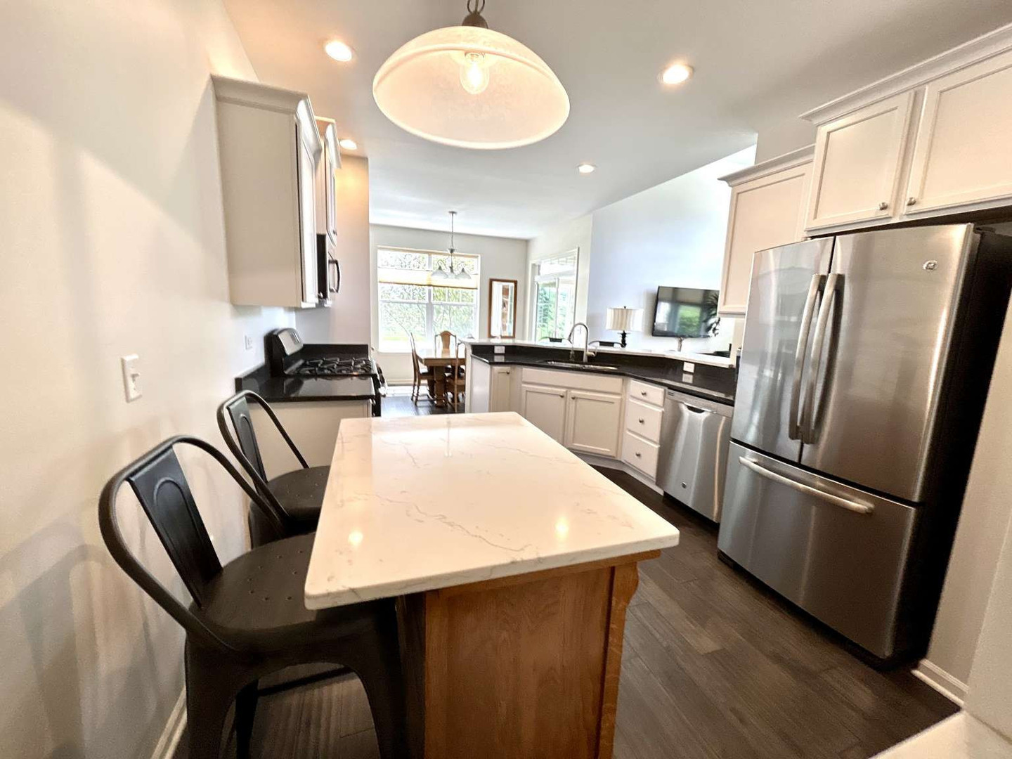 2603 Avondale Circle Naperville, IL 60564 - Photo 8 of 22 a kitchen with kitchen island a appliances dining table and a refrigerator
