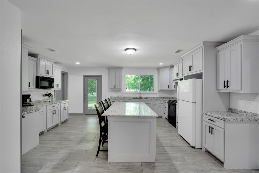 10476 County Road 313 Terrell, TX 75161 - Photo 12 of 40 a kitchen with white cabinets and stainless steel appliances