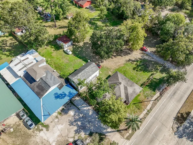 an aerial view of a house with a yard