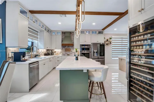 a kitchen with a sink cabinets and dining table chair