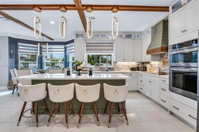 a living room with furniture fireplace and a large window