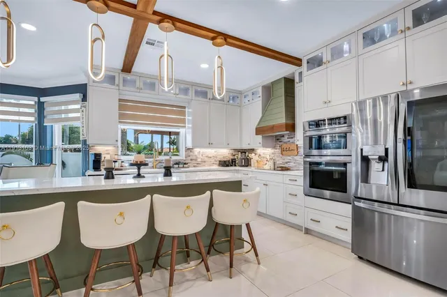 a living room with furniture a large window and flat screen tv