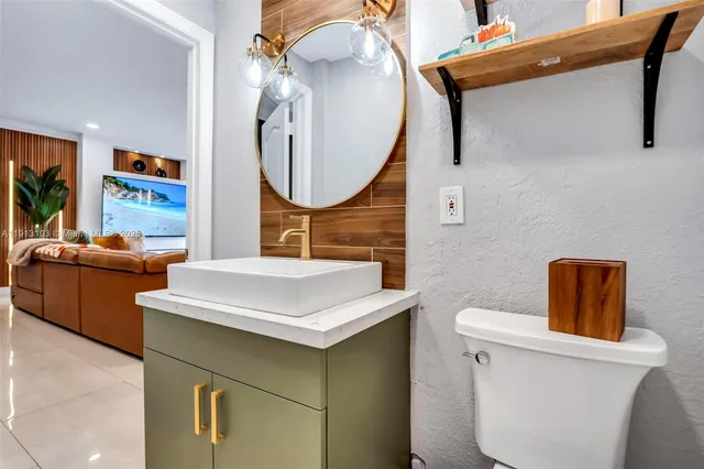 a bedroom with a large bed and a flat tv screen on dresser