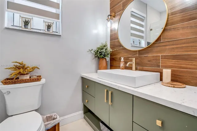 a bathroom with a toilet a sink and a mirror