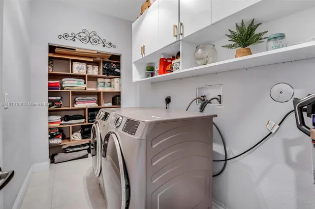 a bathroom with a double vanity sink mirror and shower