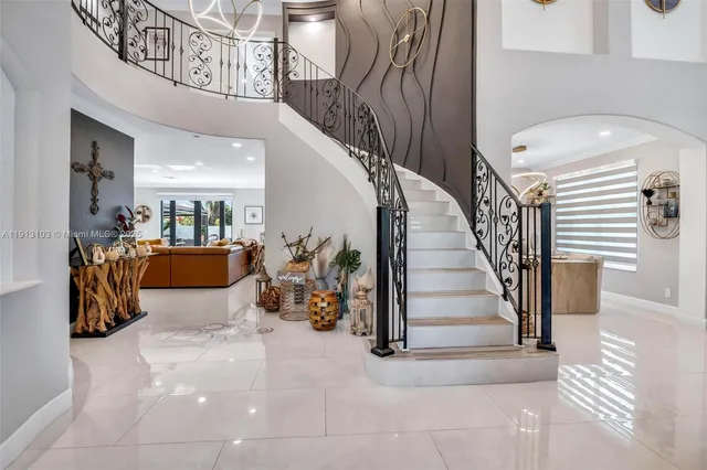 a living room with furniture kitchen view and a large window