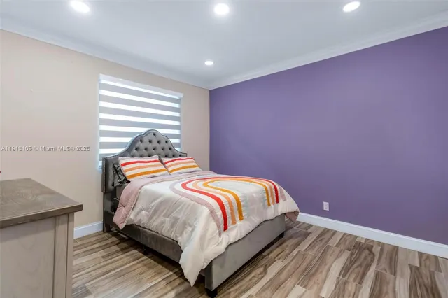 a living room with patio furniture and a chandelier