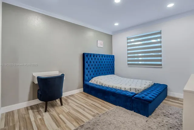 a view of a house with pool lawn chairs and potted plants