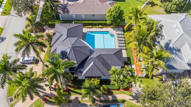 a view of backyard with swimming pool and outdoor seating