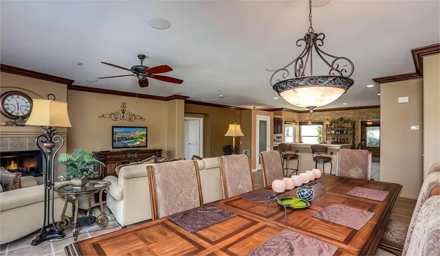 a living room with furniture a fireplace and a chandelier