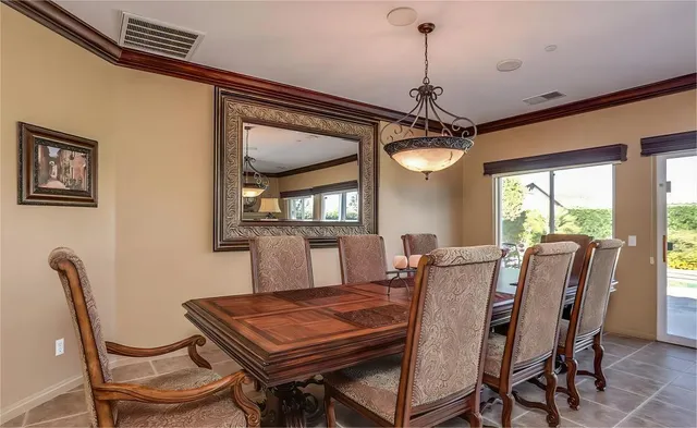 a dining room with furniture a chandelier and window