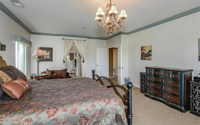 a bed room with a bed and a chandelier