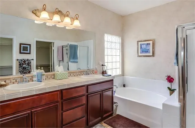 a bathroom with a tub sink and a mirror