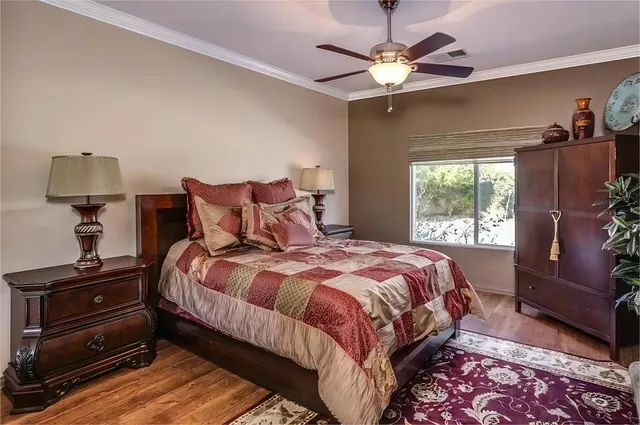 a bedroom with a bed and a chandelier