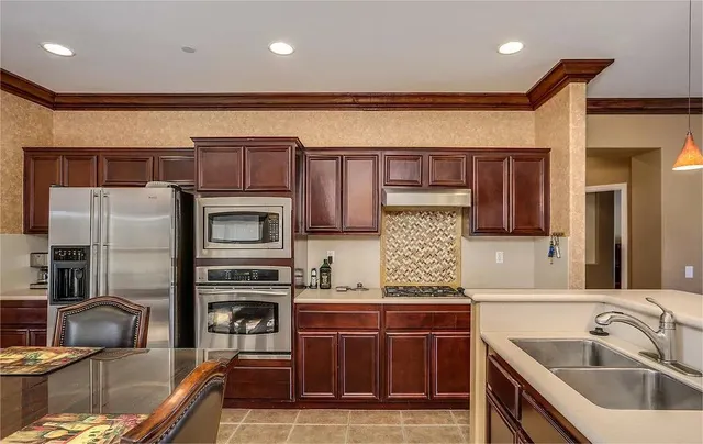 a kitchen with a sink stove and refrigerator