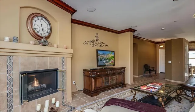 a living room with furniture a fireplace and wooden floor