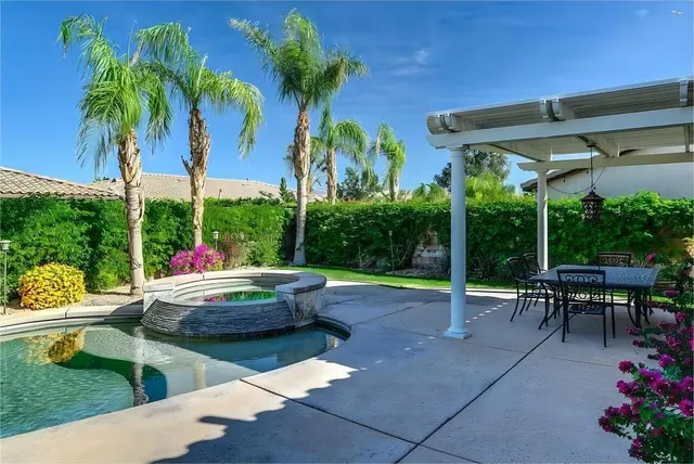 a view of a backyard with sitting area