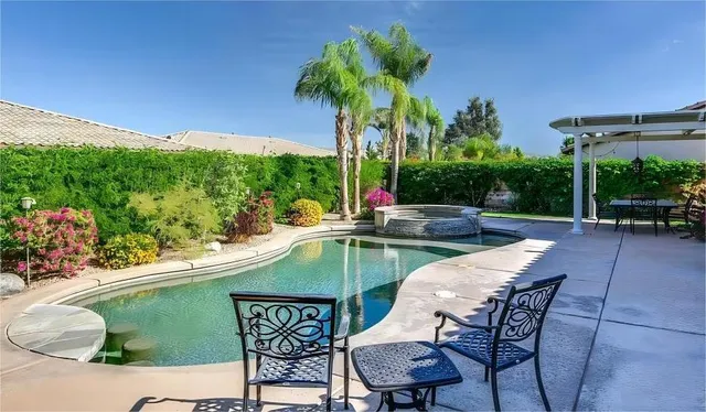 a view of a chairs and table in patio