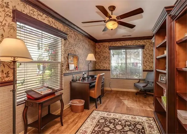 a living room with furniture a chandelier and a rug