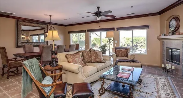 a living room with furniture a fireplace and a flat screen tv