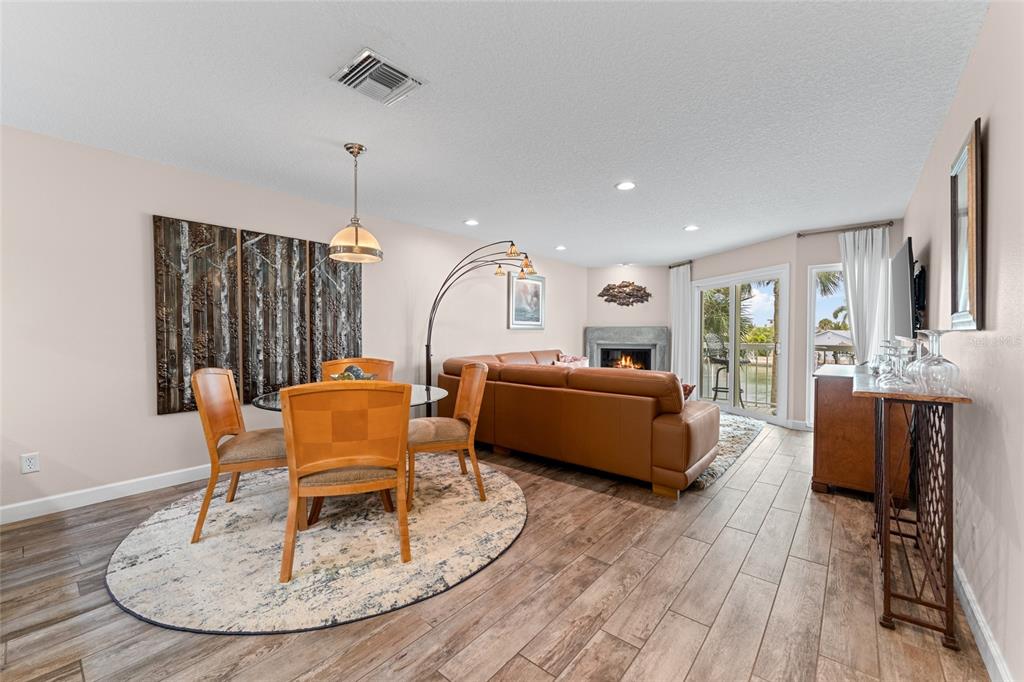 128 Marcdale Boulevard Indian Rocks Beach, FL 33785 - Photo 12 of 74 a living room with furniture kitchen view and a wooden floor