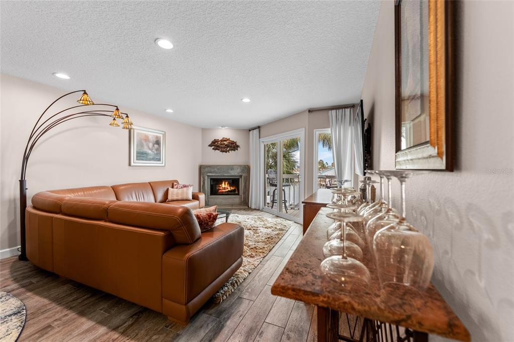 128 Marcdale Boulevard Indian Rocks Beach, FL 33785 - Photo 13 of 74 a living room with furniture and a fireplace