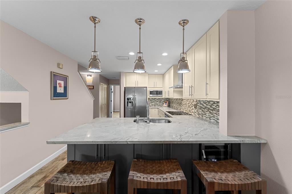 128 Marcdale Boulevard Indian Rocks Beach, FL 33785 - Photo 20 of 74 a kitchen with a table and chairs in it