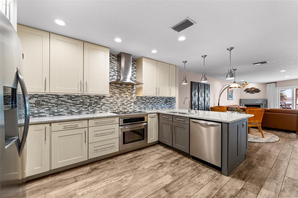 128 Marcdale Boulevard Indian Rocks Beach, FL 33785 - Photo 22 of 74 a kitchen with stainless steel appliances granite countertop a stove and a sink