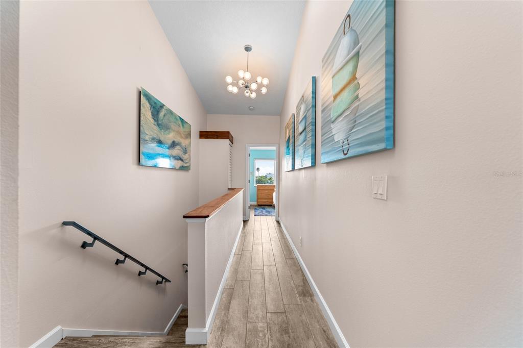 128 Marcdale Boulevard Indian Rocks Beach, FL 33785 - Photo 32 of 74 a view of a hallway with wooden floor and staircase