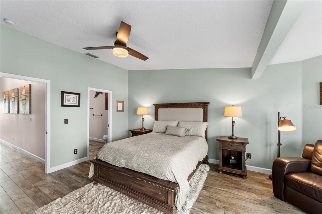 128 Marcdale Boulevard Indian Rocks Beach, FL 33785 - Photo 36 of 74 a bedroom with a bed and a chandelier