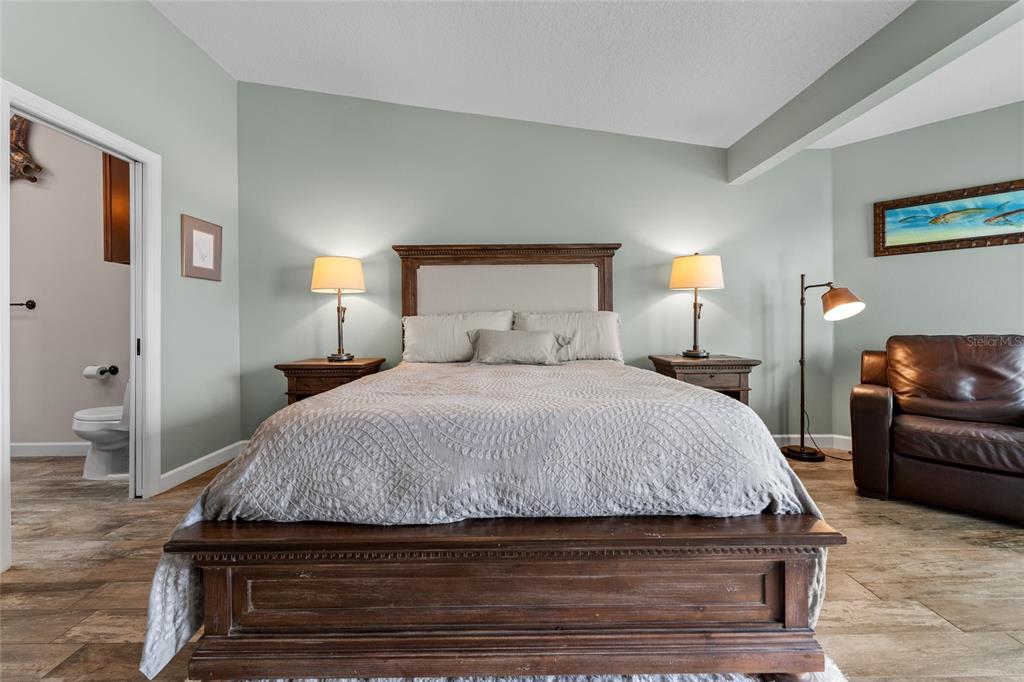 128 Marcdale Boulevard Indian Rocks Beach, FL 33785 - Photo 37 of 74 a bedroom with a bed and wooden floor