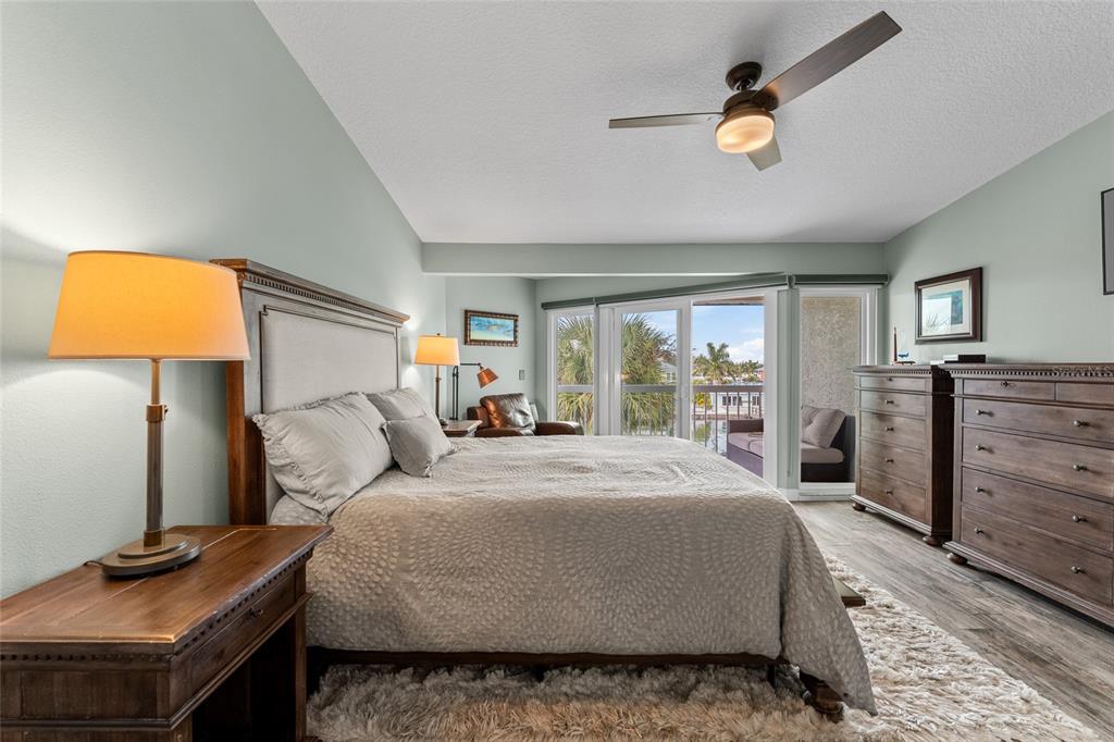 128 Marcdale Boulevard Indian Rocks Beach, FL 33785 - Photo 39 of 74 a bedroom with a bed and dresser with mirror