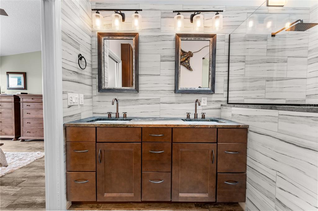 128 Marcdale Boulevard Indian Rocks Beach, FL 33785 - Photo 42 of 74 a bathroom with a double vanity sink and mirror