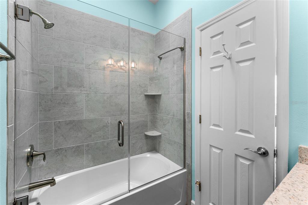 128 Marcdale Boulevard Indian Rocks Beach, FL 33785 - Photo 47 of 74 a bathroom with a glass shower door