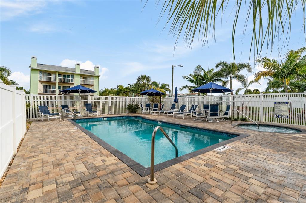 128 Marcdale Boulevard Indian Rocks Beach, FL 33785 - Photo 50 of 74 a view of a swimming pool with a lounge chairs