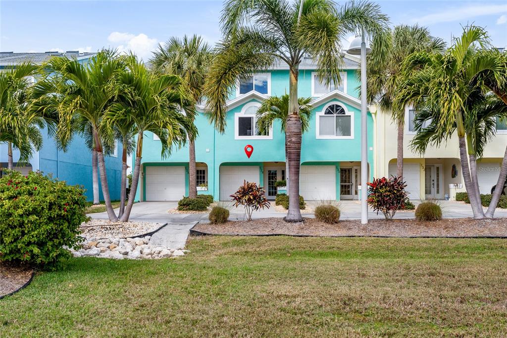 128 Marcdale Boulevard Indian Rocks Beach, FL 33785 - Photo 51 of 74 a front view of house with yard and outdoor seating