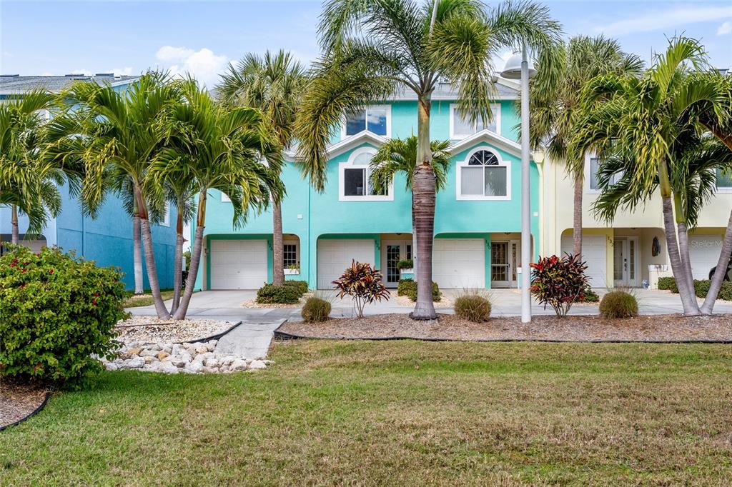 128 Marcdale Boulevard Indian Rocks Beach, FL 33785 - Photo 52 of 74 a front view of house with yard and outdoor seating