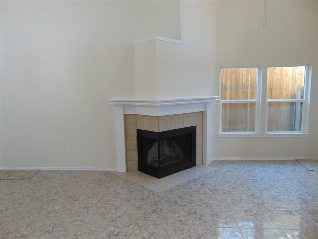 4912 Berridge Lane Dallas, TX 75227 - Photo 11 of 18 a living room with a fireplace and a window