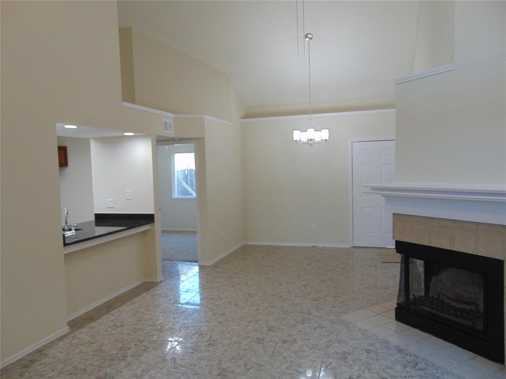 4912 Berridge Lane Dallas, TX 75227 - Photo 4 of 18 a view of a kitchen with a sink and a fireplace