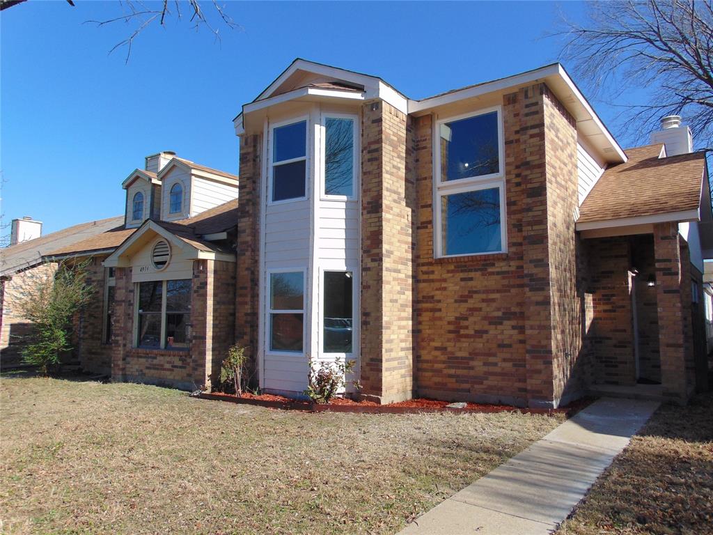 4912 Berridge Lane Dallas, TX 75227 - Photo 5 of 18 a front view of a house with a yard