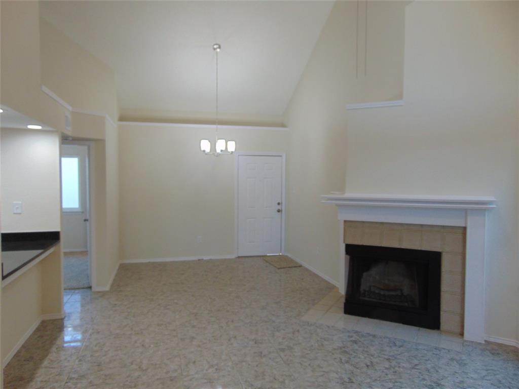 4912 Berridge Lane Dallas, TX 75227 - Photo 8 of 18 an empty room with a fireplace