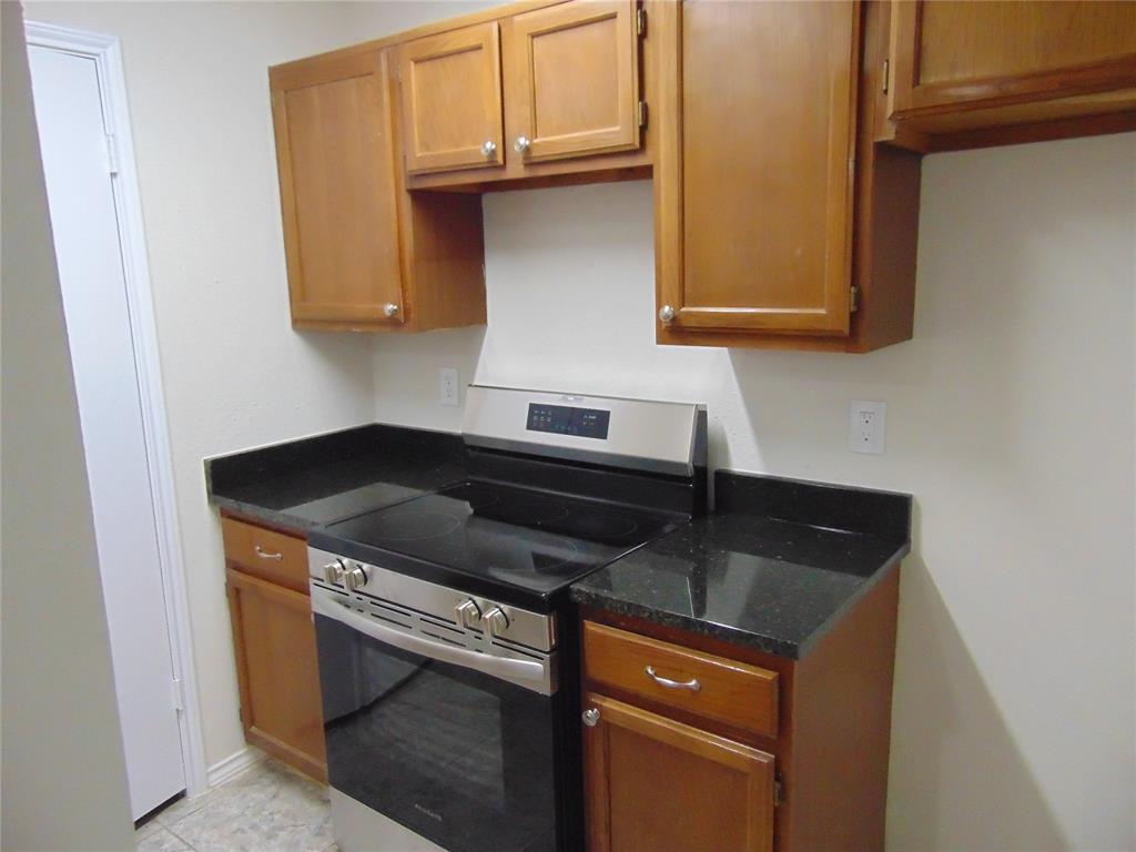 4912 Berridge Lane Dallas, TX 75227 - Photo 10 of 18 a kitchen with granite countertop a sink and cabinets