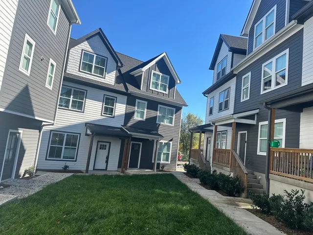 a view of a brick building next to a yard