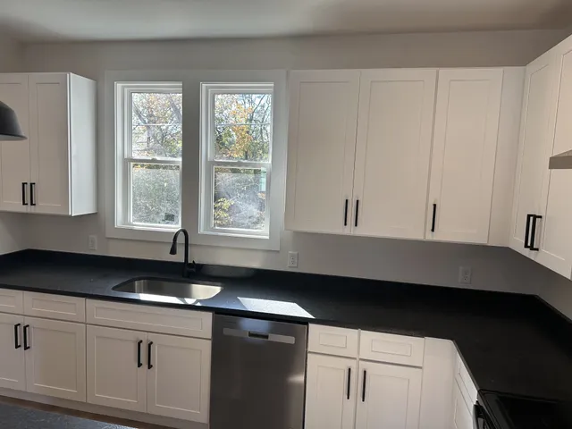 a kitchen with a sink and cabinets