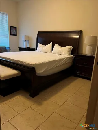 a bedroom with a bed and a cabinets